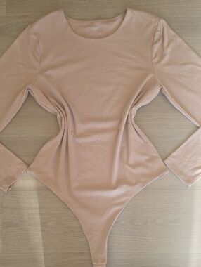 nuuds Long Sleeve Scoop Neck Bodysuit in cream.